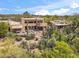 Desert home boasts an outdoor patio area, perfect for relaxation amid the lush native greenery at 1607 N Quartz Valley Rd, Scottsdale, AZ 85266