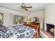 Comfortable bedroom featuring a cozy fireplace and a scenic window seat overlooking desert landscape at 1607 N Quartz Valley Rd, Scottsdale, AZ 85266