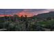 Scenic desert landscape view featuring native plants, a green golf course, and mountain views at sunrise at 1607 N Quartz Valley Rd, Scottsdale, AZ 85266