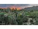 Scenic desert landscape view featuring native plants, a green golf course, and mountain views at sunrise at 1607 N Quartz Valley Rd, Scottsdale, AZ 85266