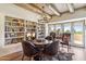 Dining room with wooden ceiling beams, custom bookshelves and golf course view at 1607 N Quartz Valley Rd, Scottsdale, AZ 85266