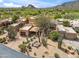 Expansive desert home showcasing native cacti and a tranquil setting near a golf course and mountain backdrop at 1607 N Quartz Valley Rd, Scottsdale, AZ 85266