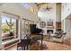 Bright living room with high ceilings, a fireplace, terra cotta floors, and grand piano at 1607 N Quartz Valley Rd, Scottsdale, AZ 85266