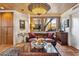 Cozy living room with a large leather sofa, decorative lighting, and a view of the exterior landscape at 1607 N Quartz Valley Rd, Scottsdale, AZ 85266