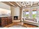 Comfortable primary bedroom boasts wood-beamed ceilings, fireplace, and desert views at 1607 N Quartz Valley Rd, Scottsdale, AZ 85266