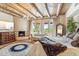 Comfortable primary bedroom boasts wood-beamed ceilings, fireplace, and bright natural light at 1607 N Quartz Valley Rd, Scottsdale, AZ 85266