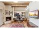 Inviting home office features a cozy fireplace, wood-beamed ceilings, and bright natural light at 1607 N Quartz Valley Rd, Scottsdale, AZ 85266