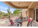 Covered patio with comfortable seating and desert landscaping at 1607 N Quartz Valley Rd, Scottsdale, AZ 85266