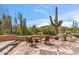 Desert landscape patio with fire pit and chairs overlooking cacti and mountain views at 1607 N Quartz Valley Rd, Scottsdale, AZ 85266