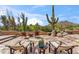 Stone patio with outdoor seating and desert plants at 1607 N Quartz Valley Rd, Scottsdale, AZ 85266
