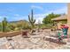 Outdoor patio seating area with desert landscaping and mountain views at 1607 N Quartz Valley Rd, Scottsdale, AZ 85266