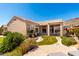 Lush backyard featuring a water fountain, a covered patio, and desert landscaping at 16211 S 4Th St, Phoenix, AZ 85048