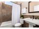 Cozy bathroom featuring tile walls, vanity sink, toilet, and shower with curtain at 16211 S 4Th St, Phoenix, AZ 85048
