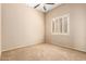 Bright bedroom featuring neutral carpet, beige walls and window with white shutters at 16211 S 4Th St, Phoenix, AZ 85048