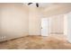 Empty bedroom featuring tile flooring, ceiling fan, and doorway to another room at 16211 S 4Th St, Phoenix, AZ 85048