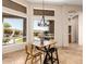 Cozy dining area offers picturesque window views and stylish chandelier lighting at 16211 S 4Th St, Phoenix, AZ 85048