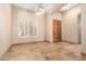 Elegant entryway featuring travertine floors, a chandelier, and a decorative front door at 16211 S 4Th St, Phoenix, AZ 85048