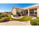 Inviting front yard featuring a lush landscape, manicured lawn, and a charming fountain at 16211 S 4Th St, Phoenix, AZ 85048