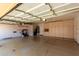 Garage featuring epoxy floor, overhead storage and ample cabinet space at 16211 S 4Th St, Phoenix, AZ 85048