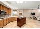 Open-concept kitchen with wood cabinetry, an island and outside views at 16211 S 4Th St, Phoenix, AZ 85048