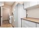 Laundry room featuring a washer, dryer, refrigerator, and extra storage at 16211 S 4Th St, Phoenix, AZ 85048