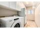Laundry room featuring a washer, dryer, refrigerator and storage cabinets at 16211 S 4Th St, Phoenix, AZ 85048
