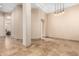 Bright open living room featuring neutral walls, tiled floors, and elegant hanging light fixtures at 16211 S 4Th St, Phoenix, AZ 85048