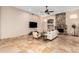 Inviting living room features vaulted ceilings, stone fireplace, a ceiling fan, and tiled flooring at 16211 S 4Th St, Phoenix, AZ 85048