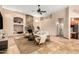 Bright living room with a stone fireplace and travertine floors, bathed in natural light at 16211 S 4Th St, Phoenix, AZ 85048