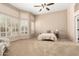 Spacious main bedroom featuring a large window, ample lighting, and plush carpeting at 16211 S 4Th St, Phoenix, AZ 85048