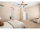 Spacious main bedroom with carpet, ceiling fan, and adjoining bathroom and sitting area at 16211 S 4Th St, Phoenix, AZ 85048