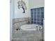 Relaxing soaking tub with glass block window feature and stylish tile surround. A perfect retreat for unwinding at 16304 E Crystal Ridge Dr, Fountain Hills, AZ 85268