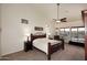 Spacious primary bedroom with a large bed, ceiling fan, and view to the backyard at 16304 E Crystal Ridge Dr, Fountain Hills, AZ 85268