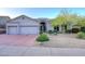 Charming home displaying a manicured front yard, desert landscaping, and a spacious three car garage at 16304 E Crystal Ridge Dr, Fountain Hills, AZ 85268