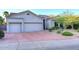 Exterior view displaying a manicured front yard, desert landscaping, three car garage and well maintained home at 16304 E Crystal Ridge Dr, Fountain Hills, AZ 85268