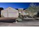 Exterior elevation of a one-story house with a three-car garage and desert landscaping at 16304 E Crystal Ridge Dr, Fountain Hills, AZ 85268