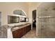 Well-lit bathroom featuring a double vanity with granite countertops and glass shower at 16304 E Crystal Ridge Dr, Fountain Hills, AZ 85268