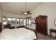 Bright main bedroom with a ceiling fan, television, and backyard view at 16304 E Crystal Ridge Dr, Fountain Hills, AZ 85268