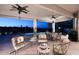 Inviting covered patio with seating, ceiling fans, and captivating views of the pool and desert landscape at 16304 E Crystal Ridge Dr, Fountain Hills, AZ 85268