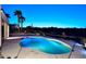 Backyard with a pool, water feature, and desert landscaping at dusk at 16304 E Crystal Ridge Dr, Fountain Hills, AZ 85268