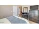 Comfortable bedroom with tile flooring, dark wood furniture, and a queen-sized bed, offering ample space at 1633 E Lakeside Dr # 139, Gilbert, AZ 85234