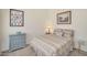 Bright bedroom with neutral tones, framed artwork, dresser, side tables, and patterned bedding at 1633 E Lakeside Dr # 139, Gilbert, AZ 85234