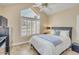 Bright bedroom showcasing shuttered windows, a pitched ceiling, and a comfortable bed with a blue accent at 1633 E Lakeside Dr # 139, Gilbert, AZ 85234