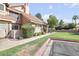Charming home featuring a well-manicured lawn, mature trees, and a welcoming front entrance at 1633 E Lakeside Dr # 139, Gilbert, AZ 85234