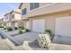 Row of attached garages with white doors, landscaping, and paved driveways at 1633 E Lakeside Dr # 139, Gilbert, AZ 85234