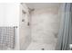Shower stall featuring gray tiling, built-in shelving, and a rainfall shower head at 1633 E Lakeside Dr # 139, Gilbert, AZ 85234