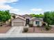 Aerial view showcasing the home's landscaped front yard and the neighborhood at 16861 W Ironwood St, Surprise, AZ 85388