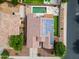 An overhead shot features a home with solar panels, a pristine pool, and an artificial grass backyard at 16861 W Ironwood St, Surprise, AZ 85388
