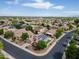 This aerial shot highlights a community with homes featuring solar panels, landscaped yards, and well-maintained streets at 16861 W Ironwood St, Surprise, AZ 85388