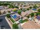 An aerial perspective captures homes with solar panels, pools, and landscaped backyards in a peaceful neighborhood at 16861 W Ironwood St, Surprise, AZ 85388